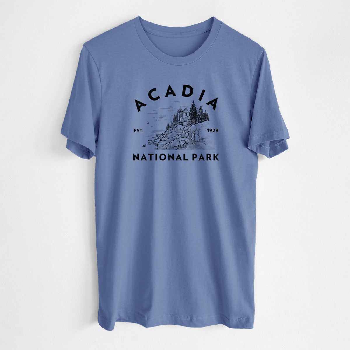 Blue bell lightweight cotton t-shirt laid flat, printed with a round badge of a rocky coastline and pine trees, with the words Acadia National Park, Est. 1929.