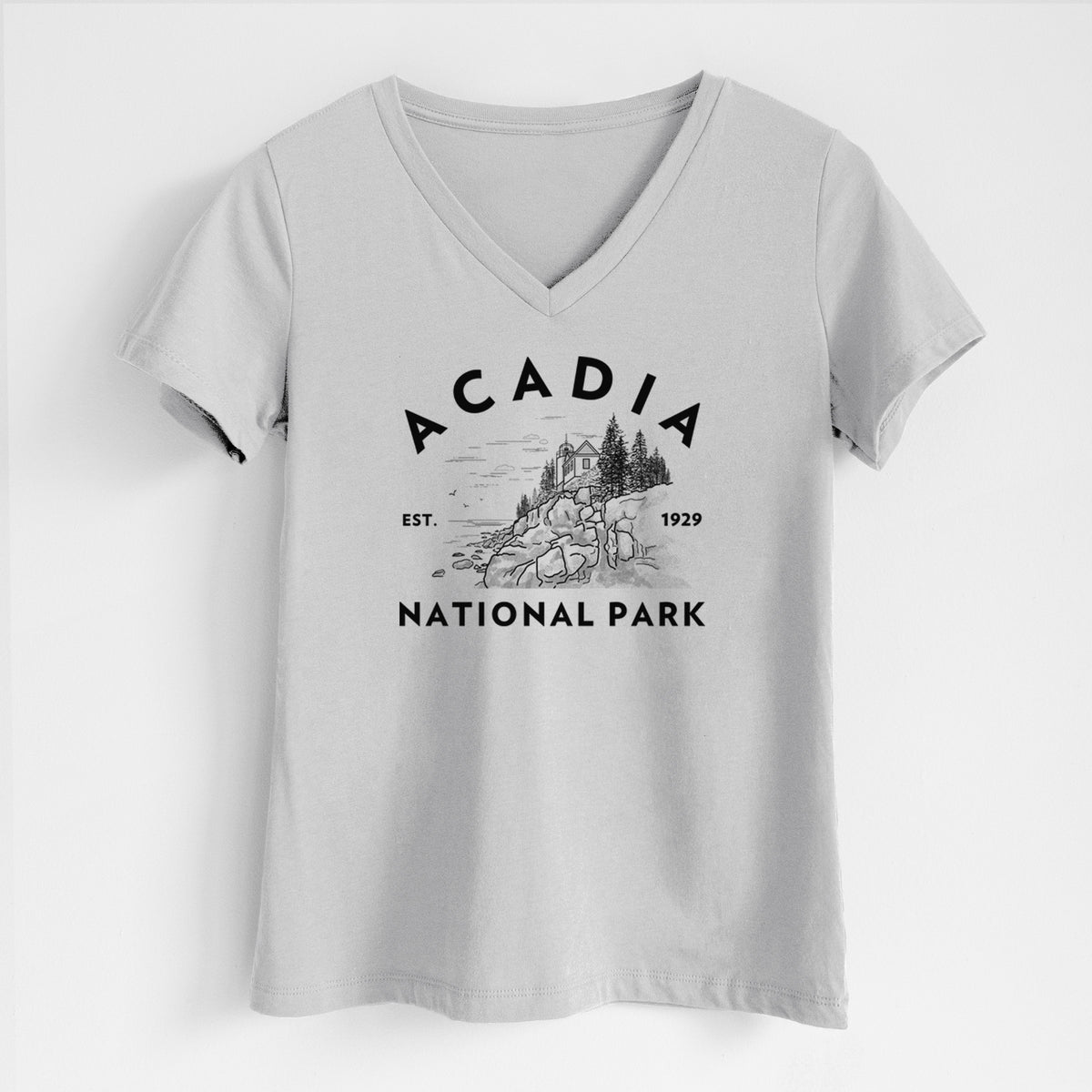 Lunar grey women's relaxed fit cotton V-neck t-shirt laid flat, printed with a round badge of a rocky coastline and pine trees, with the words Acadia National Park, Est. 1929.