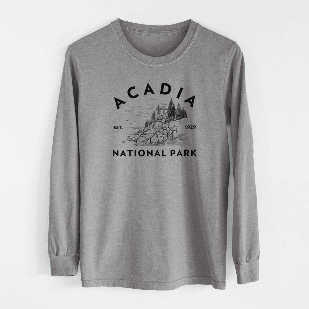 Grey Comfort Colors long sleeve shirt laid flat, printed with a round badge of a rocky coastline and pine trees, with the words Acadia National Park, Est. 1929.