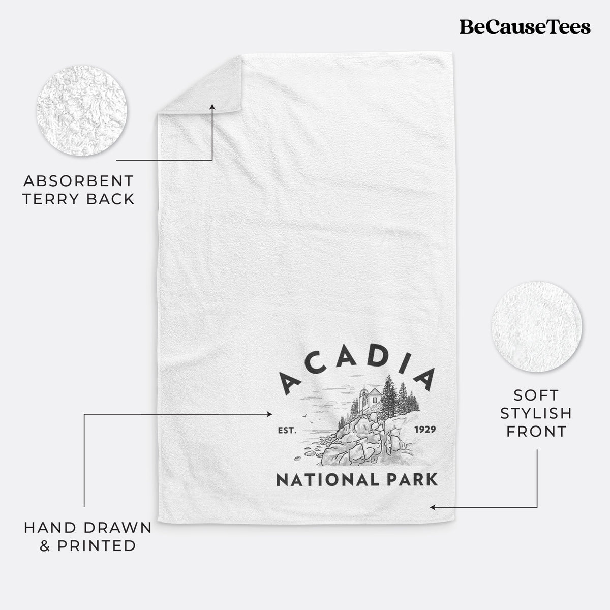 White hand towel printed with a round badge of a rocky coastline and pine trees, with the words Acadia National Park, Est. 1929.