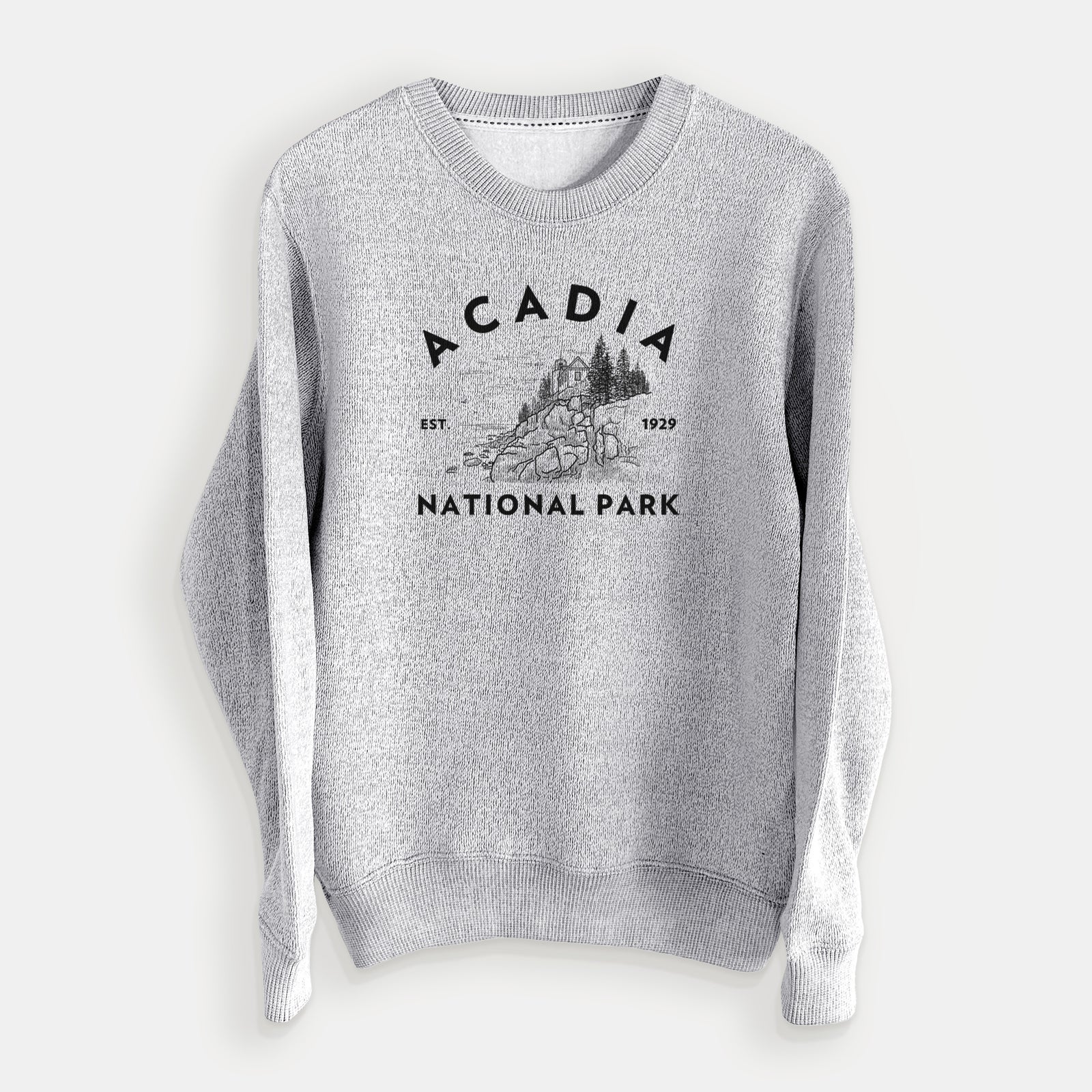 Salt and pepper knit sweatshirt laid flat, printed with a round badge of a rocky coastline and pine trees, with the words Acadia National Park, Est. 1929.