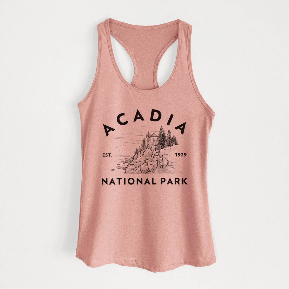 Desert pink women's racerback tank top laid flat, printed with a round badge of a rocky coastline and pine trees, with the words Acadia National Park, Est. 1929.