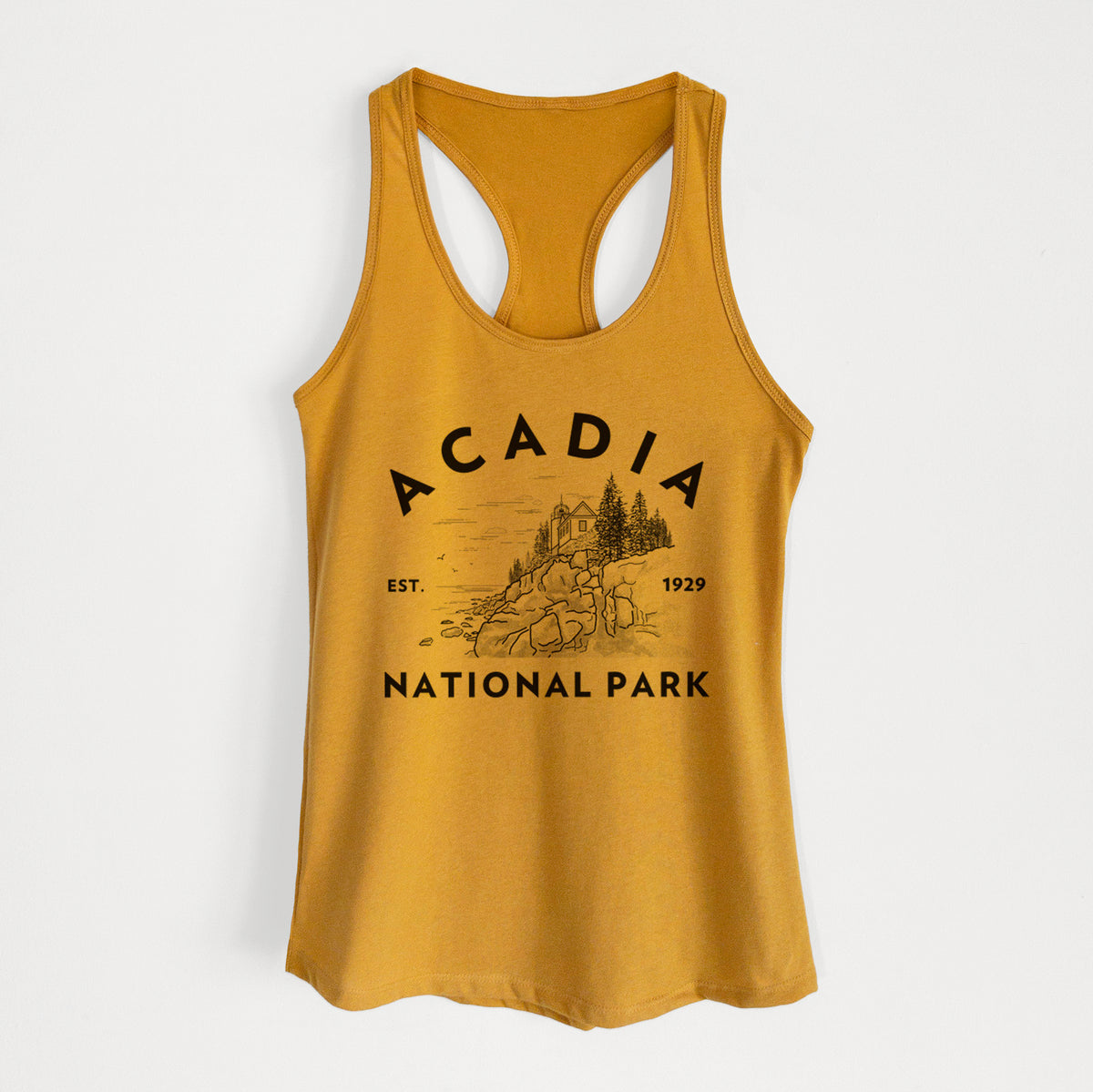 Gold women's racerback tank top laid flat, printed with a round badge of a rocky coastline and pine trees, with the words Acadia National Park, Est. 1929.