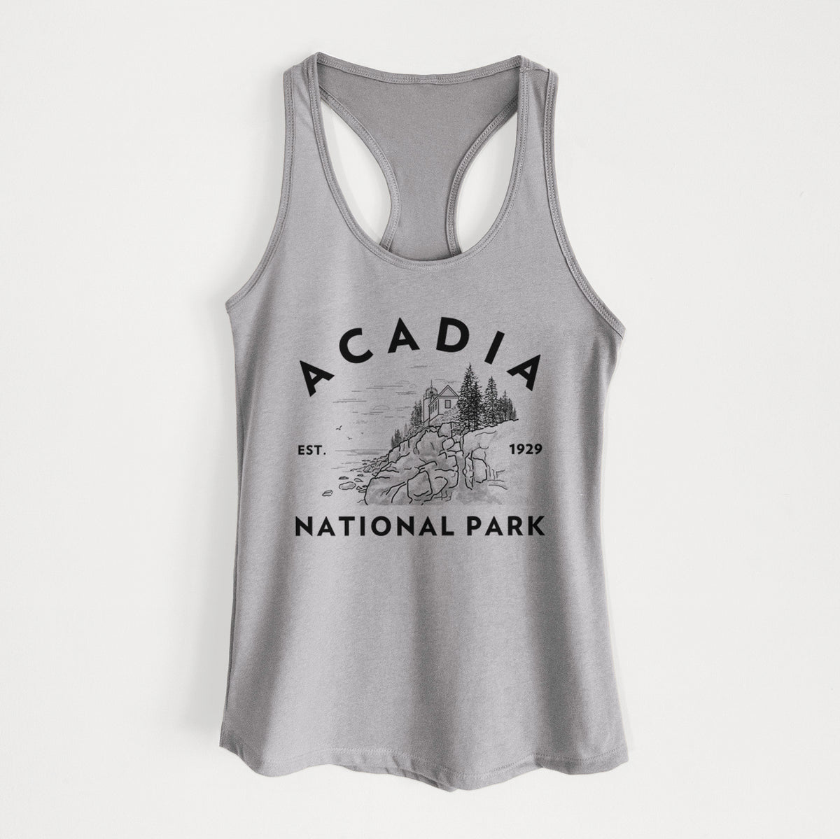 Heather grey women's racerback tank top laid flat, printed with a round badge of a rocky coastline and pine trees, with the words Acadia National Park, Est. 1929.