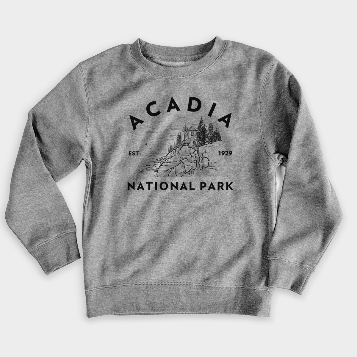 Nickel grey youth crewneck sweatshirt laid flat, printed with a round badge of a rocky coastline and pine trees, with the words Acadia National Park, Est. 1929.