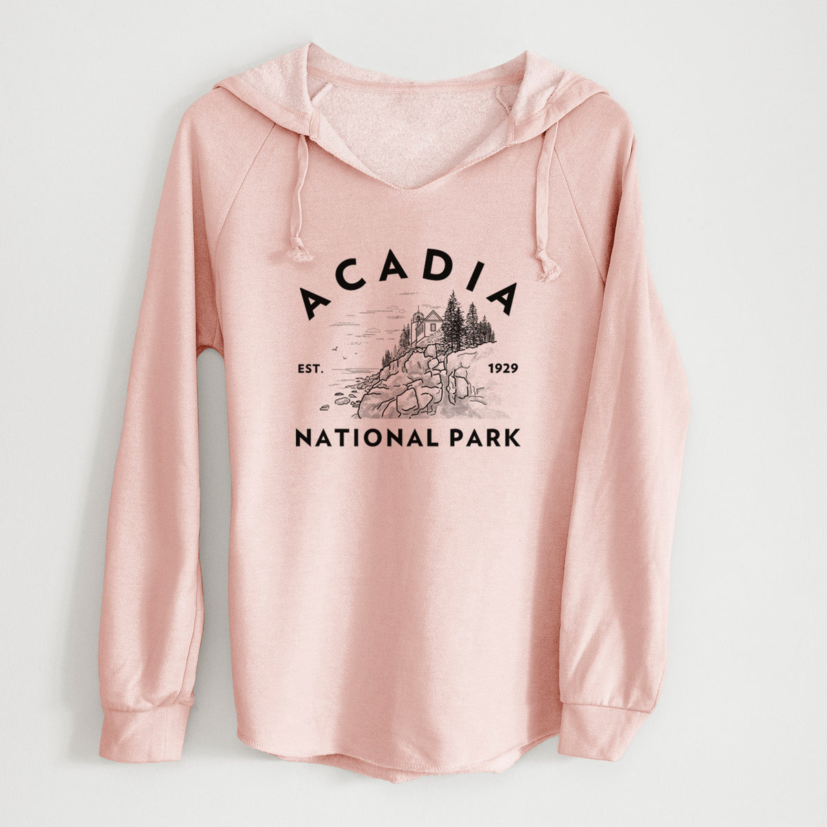 Blush pink women's Cali Wave hooded sweatshirt laid flat, printed with a round badge of a rocky coastline and pine trees, with the words Acadia National Park, Est. 1929.