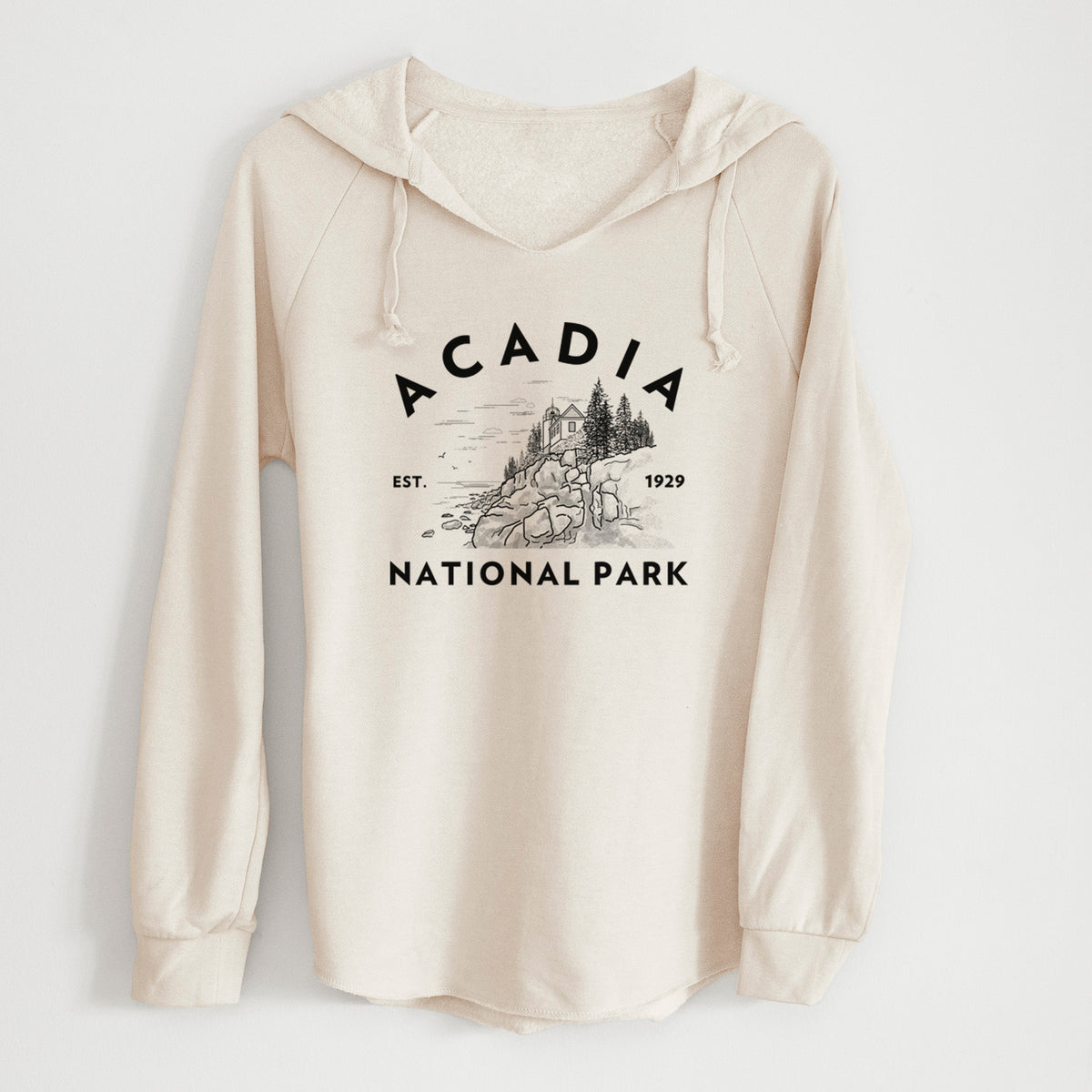 Bone cream women's Cali Wave hooded sweatshirt laid flat, printed with a round badge of a rocky coastline and pine trees, with the words Acadia National Park, Est. 1929.