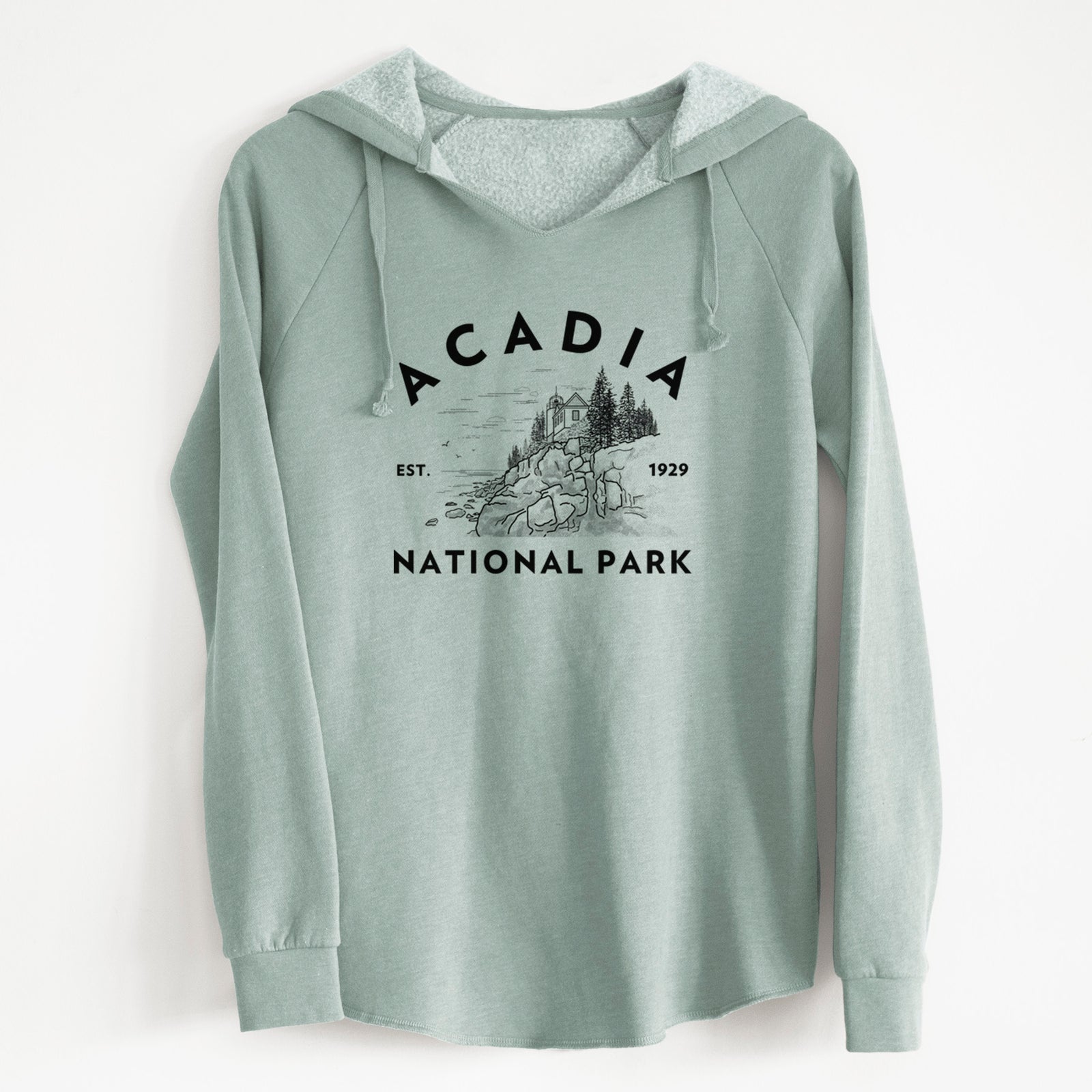 Sage green women's Cali Wave hooded sweatshirt laid flat, printed with a round badge of a rocky coastline and pine trees, with the words Acadia National Park, Est. 1929.