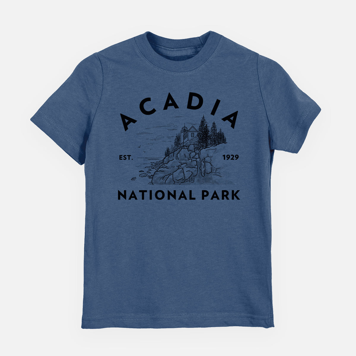 Indigo blue youth t-shirt laid flat, printed with a round badge of a rocky coastline and pine trees, with the words Acadia National Park, Est. 1929.