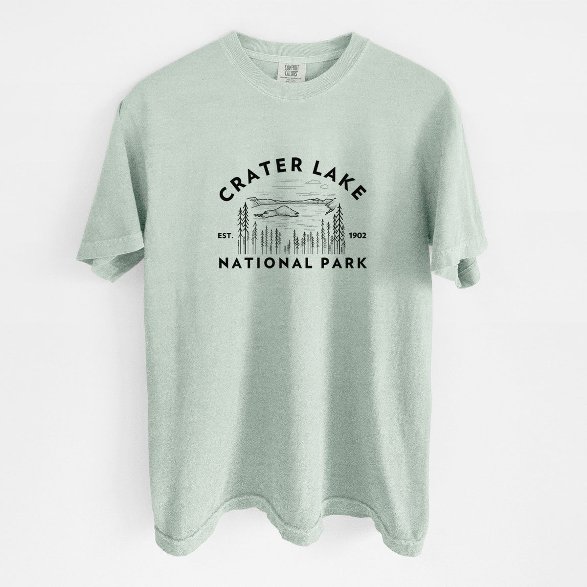 Bay green Comfort Colors t-shirt laid flat, printed with a round badge of Crater Lake ringed by pine trees, with the words Crater Lake National Park, Est. 1902.