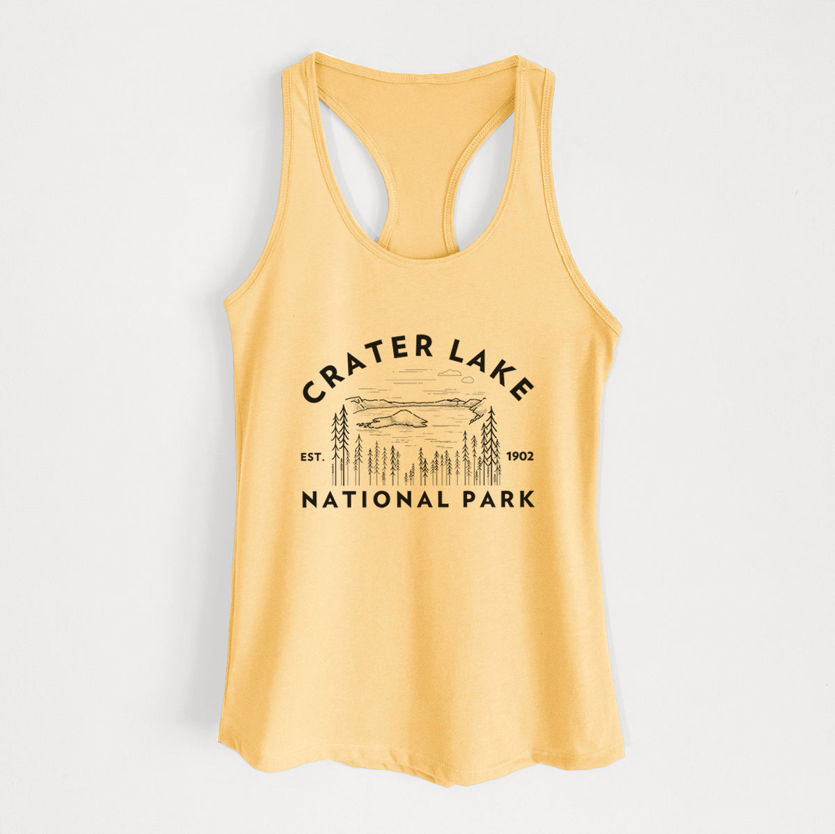 Banana cream women's racerback tank top laid flat, printed with a round badge of Crater Lake ringed by pine trees, with the words Crater Lake National Park, Est. 1902.