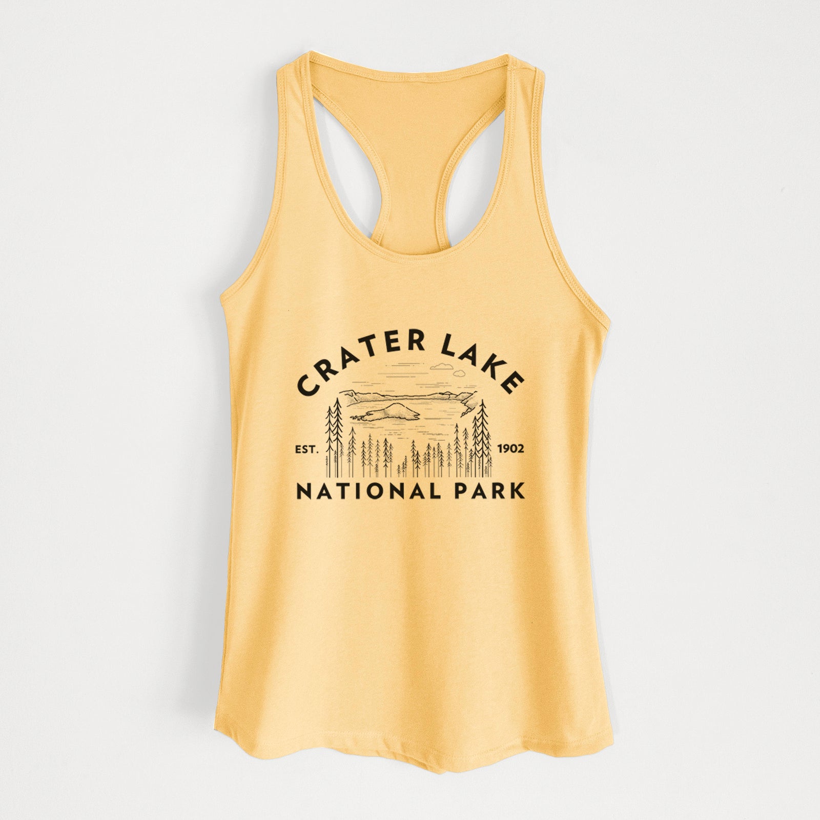 Banana cream women's racerback tank top laid flat, printed with a round badge of Crater Lake ringed by pine trees, with the words Crater Lake National Park, Est. 1902.