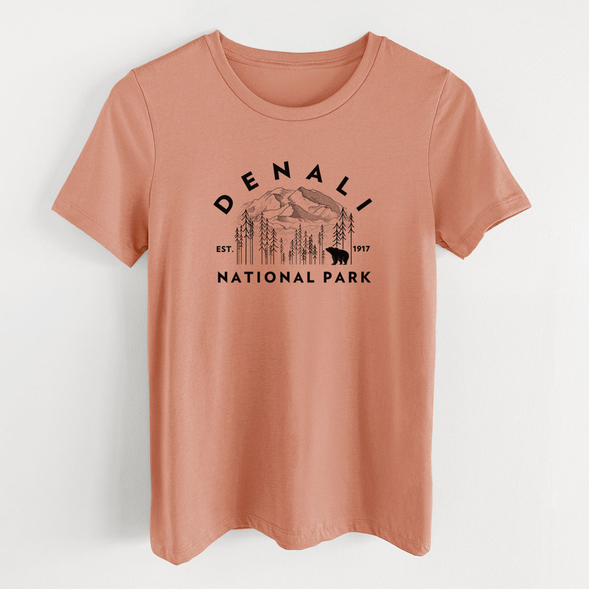 Terracotta orange women's relaxed fit cotton t-shirt laid flat, printed with a round badge of mountains, pine trees and a bear, with the words Denali National Park, Est. 1917.