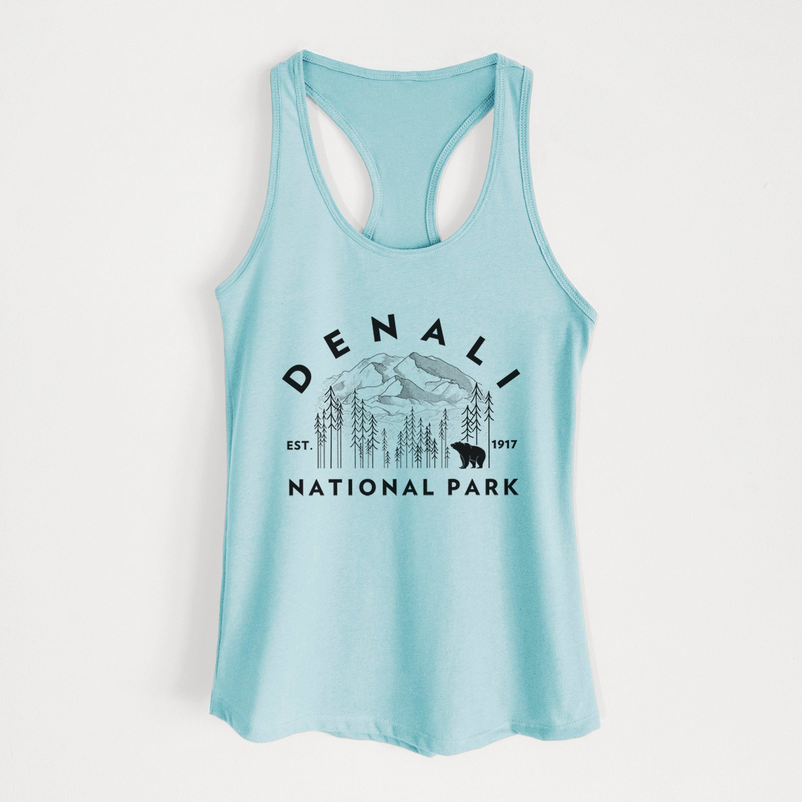 Banana cream women's racerback tank top laid flat, printed with a round badge of mountains, pine trees and a bear, with the words Denali National Park, Est. 1917.