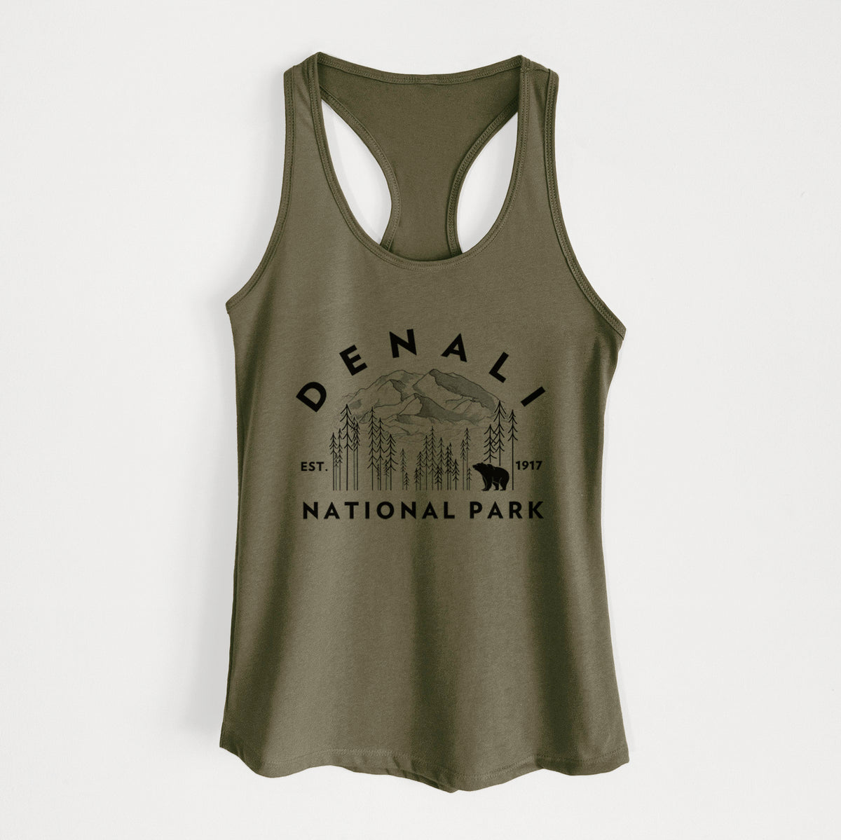 Military green women's racerback tank top laid flat, printed with a round badge of mountains, pine trees and a bear, with the words Denali National Park, Est. 1917.