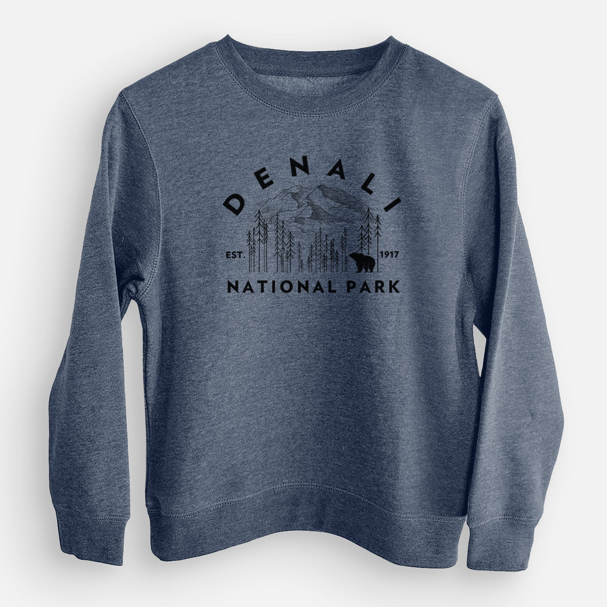 Storm blue youth crewneck sweatshirt laid flat, printed with a round badge of mountains, pine trees and a bear, with the words Denali National Park, Est. 1917.