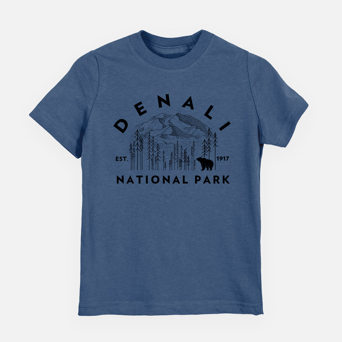 Indigo blue youth t-shirt laid flat, printed with a round badge of mountains, pine trees and a bear, with the words Denali National Park, Est. 1917.