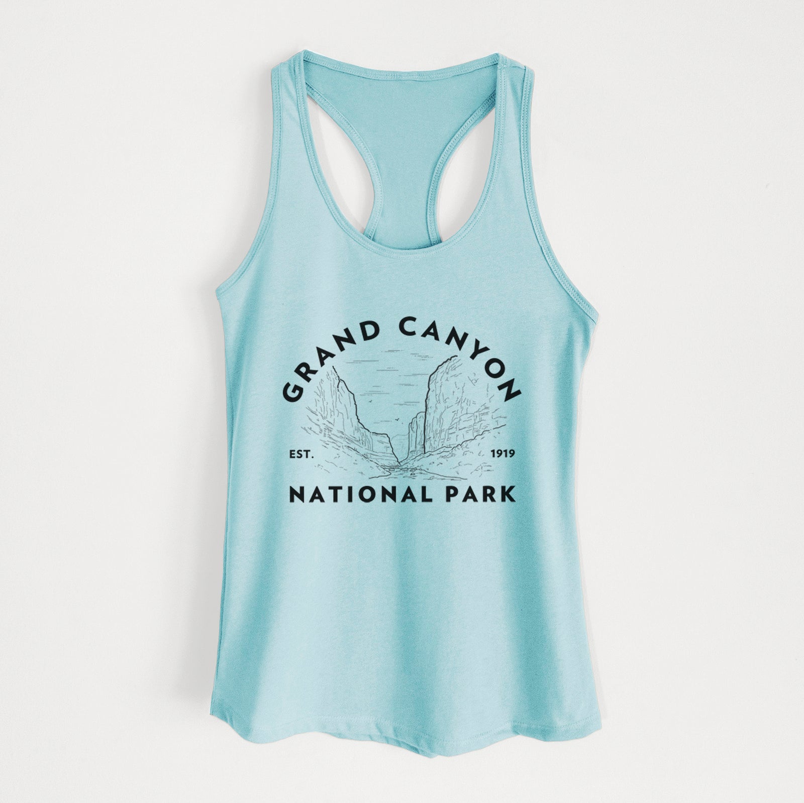 Banana cream women's racerback tank top laid flat, printed with a round badge of canyon cliffs, with the words Grand Canyon National Park, Est. 1919.