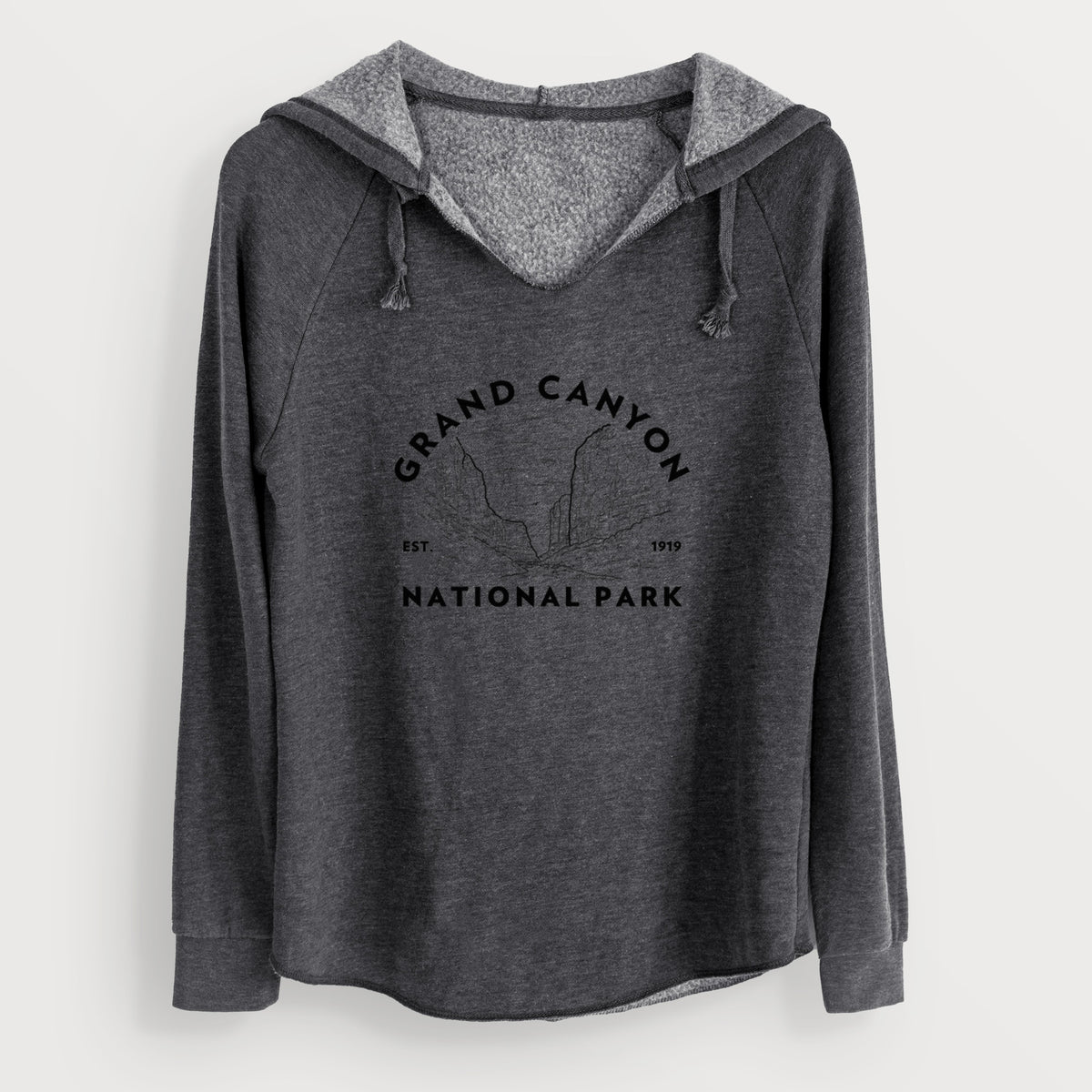 Charcoal grey women's Cali Wave hooded sweatshirt laid flat, printed with a round badge of canyon cliffs, with the words Grand Canyon National Park, Est. 1919.