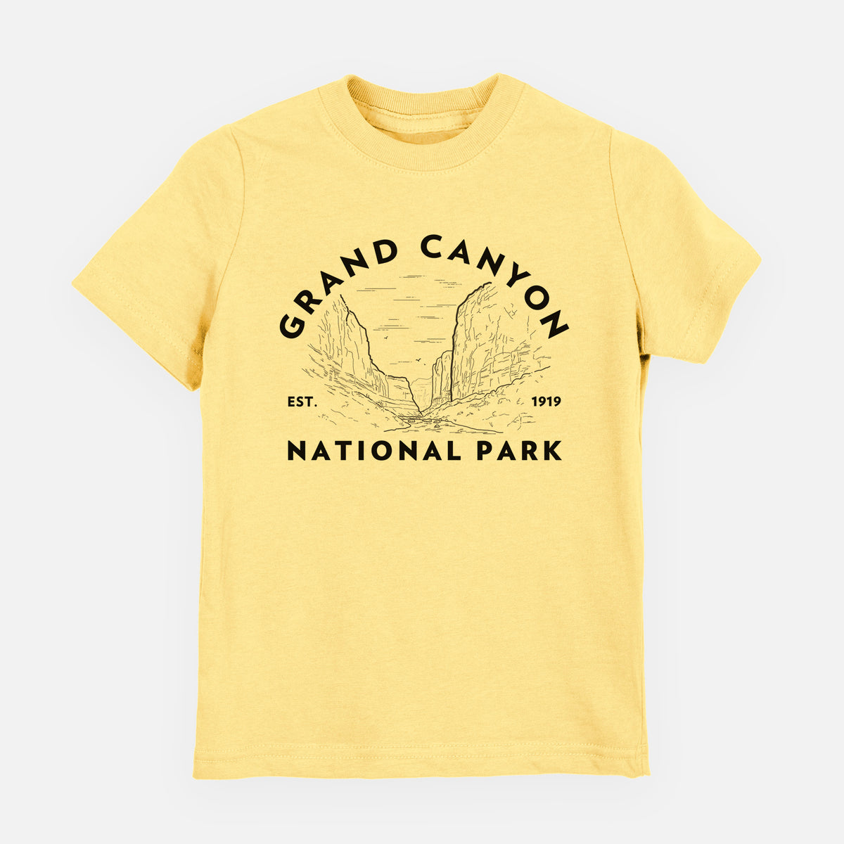 Butter yellow youth t-shirt laid flat, printed with a round badge of canyon cliffs, with the words Grand Canyon National Park, Est. 1919.