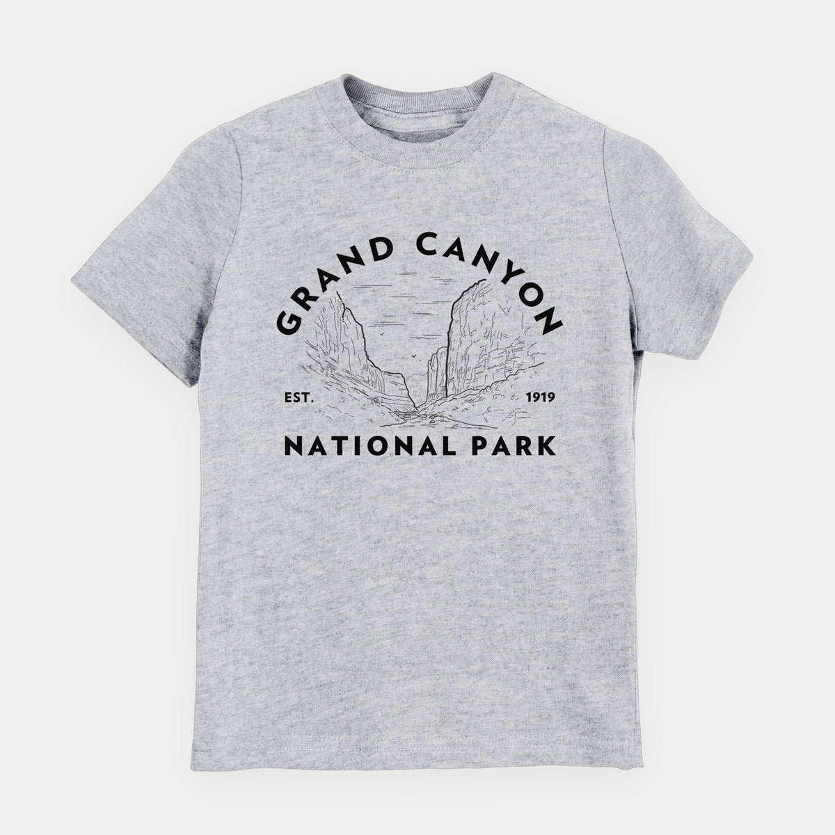 Heather grey youth t-shirt laid flat, printed with a round badge of canyon cliffs, with the words Grand Canyon National Park, Est. 1919.
