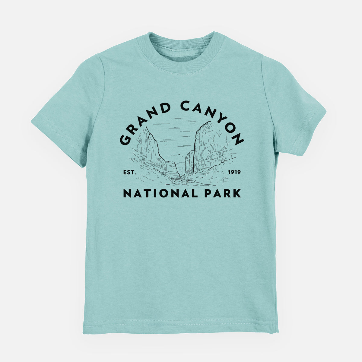 Saltwater youth t-shirt laid flat, printed with a round badge of canyon cliffs, with the words Grand Canyon National Park, Est. 1919.