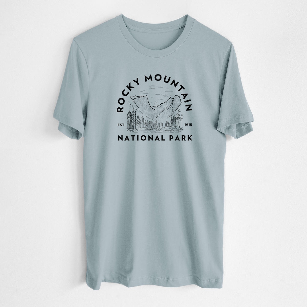 Vintage denim lightweight cotton t-shirt laid flat, printed with a round badge of mountains and pine trees, with the words Rocky Mountain National Park, Est. 1915.