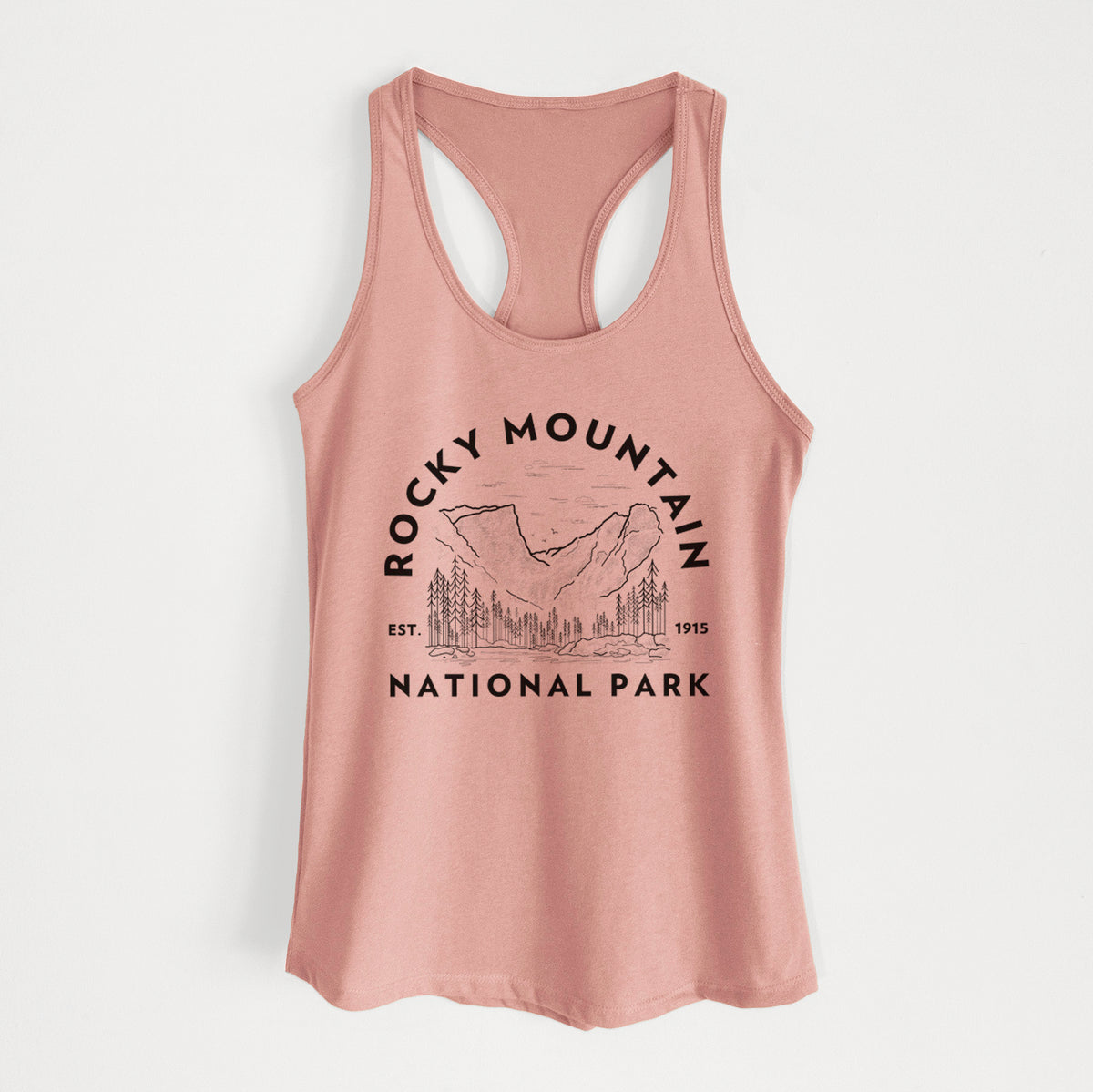 Desert pink women's racerback tank top laid flat, printed with a round badge of mountains and pine trees, with the words Rocky Mountain National Park, Est. 1915.