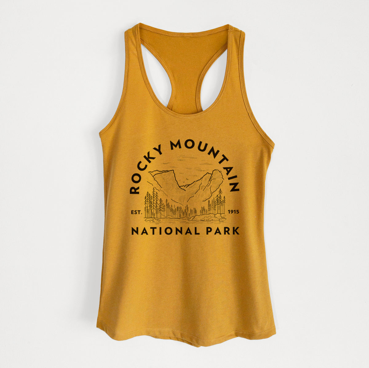 Gold women's racerback tank top laid flat, printed with a round badge of mountains and pine trees, with the words Rocky Mountain National Park, Est. 1915.