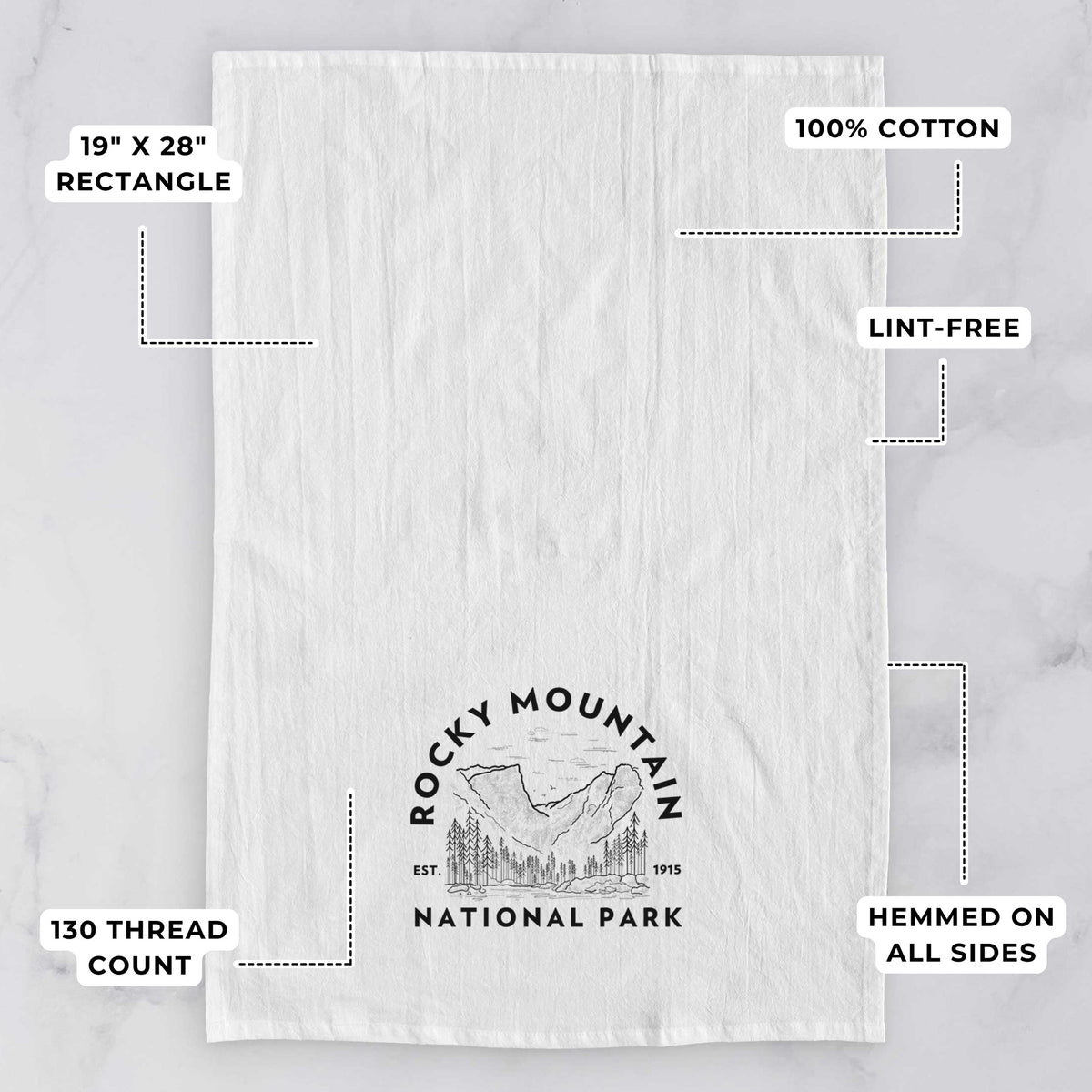 White tea towel printed with a round badge of mountains and pine trees, with the words Rocky Mountain National Park, Est. 1915, with feature labels: 19 by 28 inch rectangle, 100% cotton, lint-free, 130 thread count, hemmed on all sides.