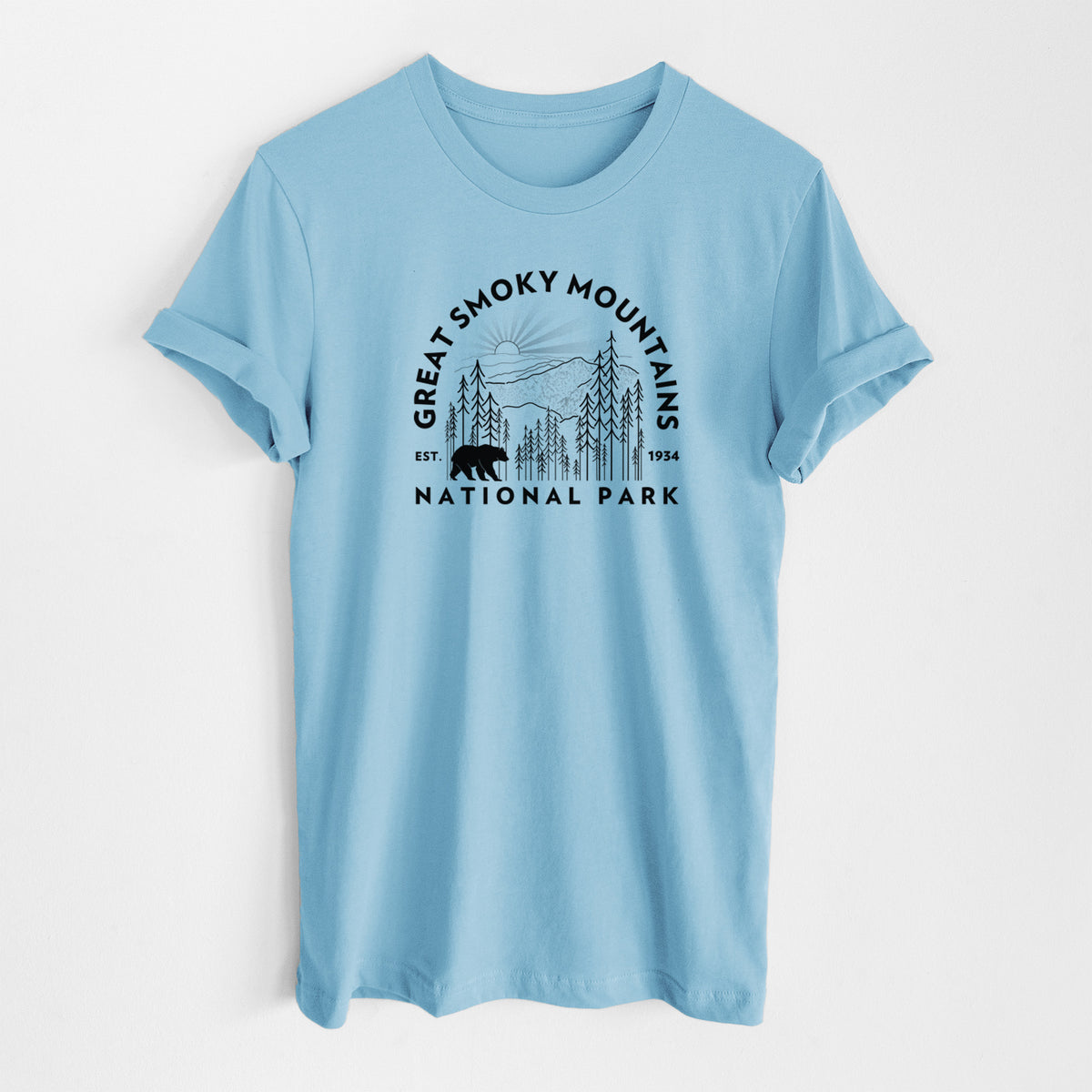Ocean blue lightweight cotton t-shirt laid flat, printed with a round badge of mountains, pine trees and a black bear, with the words Great Smoky Mountains National Park, Est. 1934.