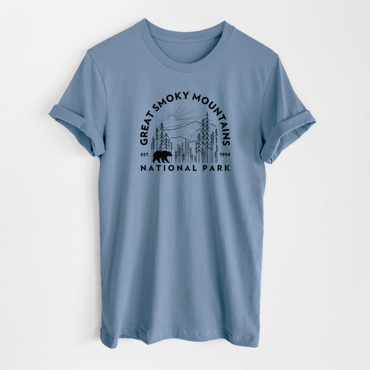 Steel blue lightweight cotton t-shirt laid flat, printed with a round badge of mountains, pine trees and a black bear, with the words Great Smoky Mountains National Park, Est. 1934.