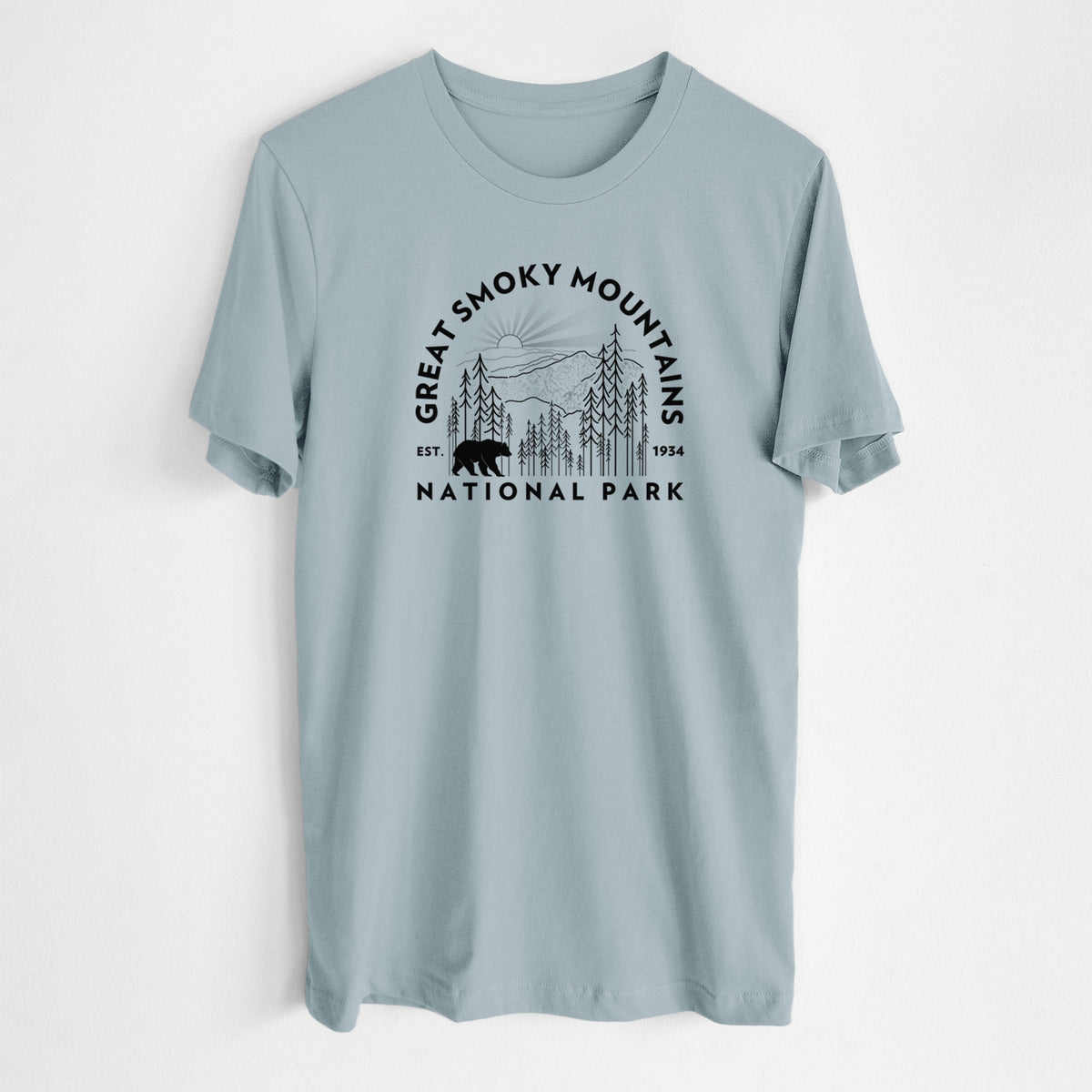 Vintage denim lightweight cotton t-shirt laid flat, printed with a round badge of mountains, pine trees and a black bear, with the words Great Smoky Mountains National Park, Est. 1934.