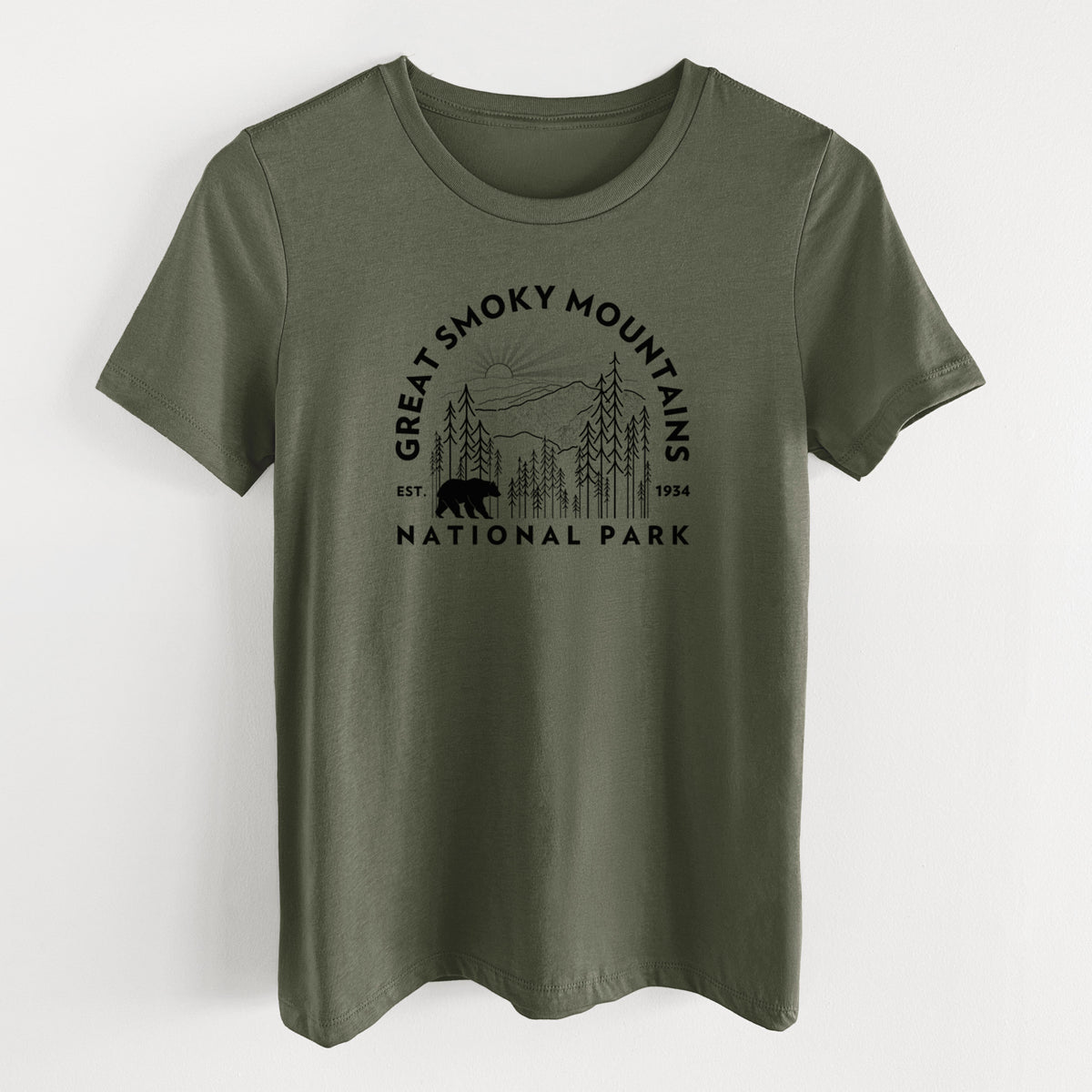 Military green women's relaxed fit cotton t-shirt laid flat, printed with a round badge of mountains, pine trees and a black bear, with the words Great Smoky Mountains National Park, Est. 1934.