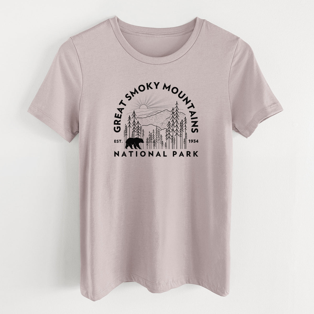 Pink gravel women's relaxed fit cotton t-shirt laid flat, printed with a round badge of mountains, pine trees and a black bear, with the words Great Smoky Mountains National Park, Est. 1934.