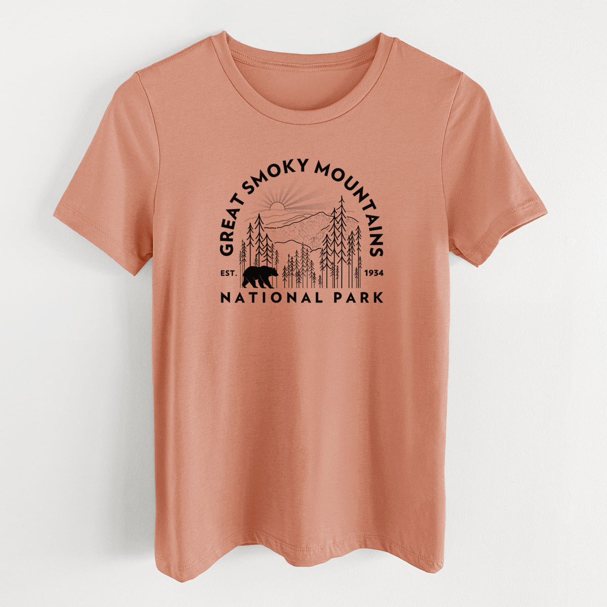 Terracotta orange women's relaxed fit cotton t-shirt laid flat, printed with a round badge of mountains, pine trees and a black bear, with the words Great Smoky Mountains National Park, Est. 1934.