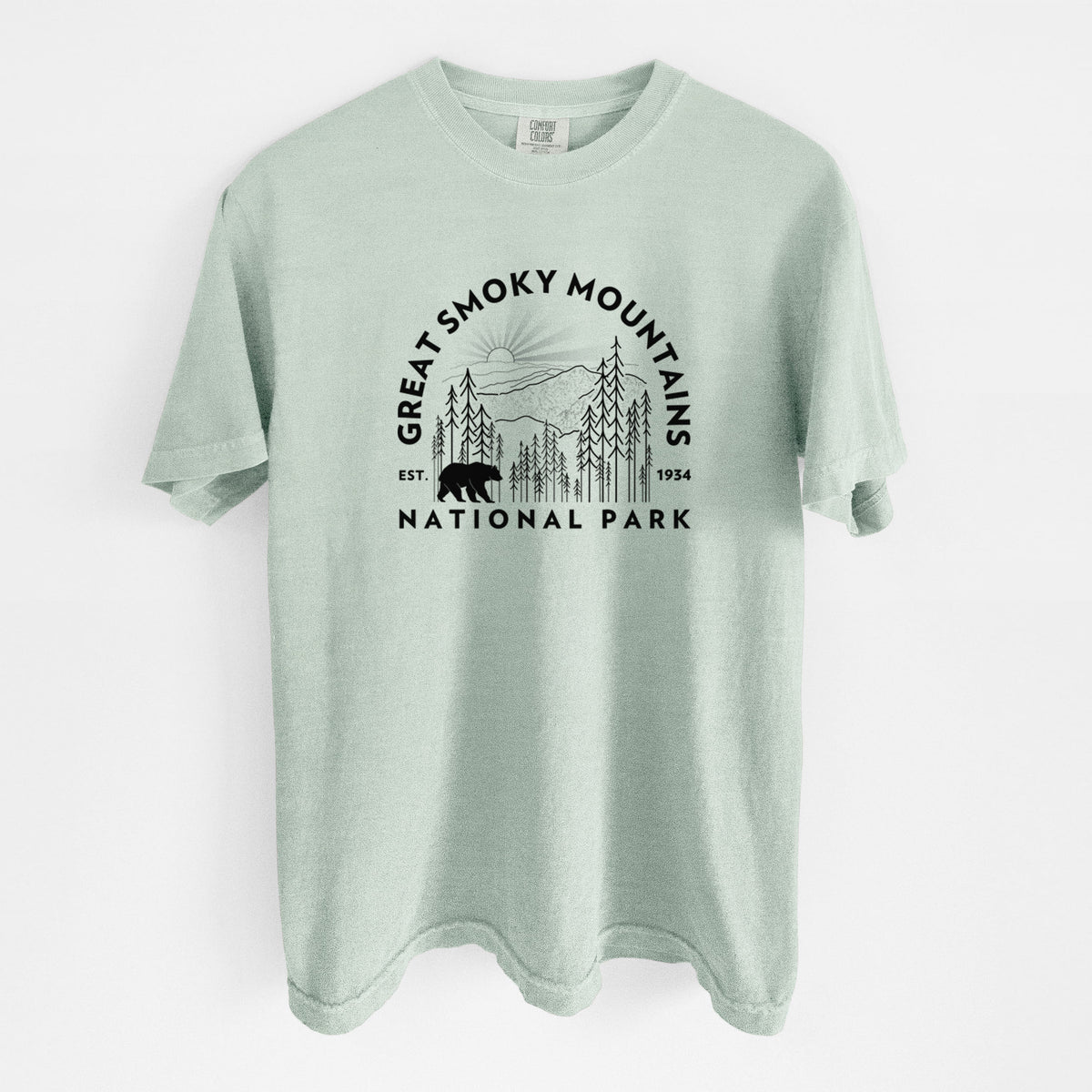 Bay green Comfort Colors t-shirt laid flat, printed with a round badge of mountains, pine trees and a black bear, with the words Great Smoky Mountains National Park, Est. 1934.