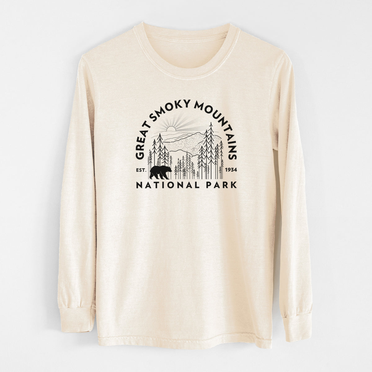 Ivory Comfort Colors long sleeve shirt laid flat, printed with a round badge of mountains, pine trees and a black bear, with the words Great Smoky Mountains National Park, Est. 1934.