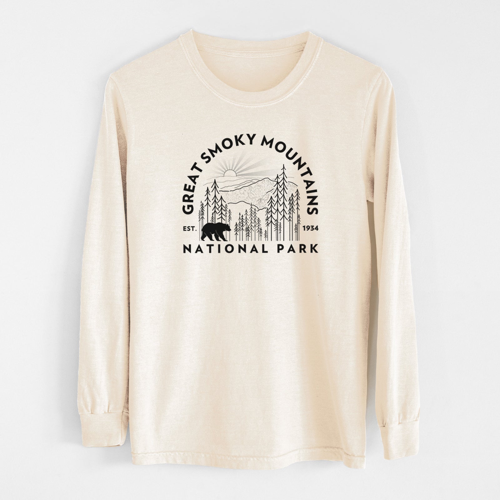 Ivory Comfort Colors long sleeve shirt laid flat, printed with a round badge of mountains, pine trees and a black bear, with the words Great Smoky Mountains National Park, Est. 1934.