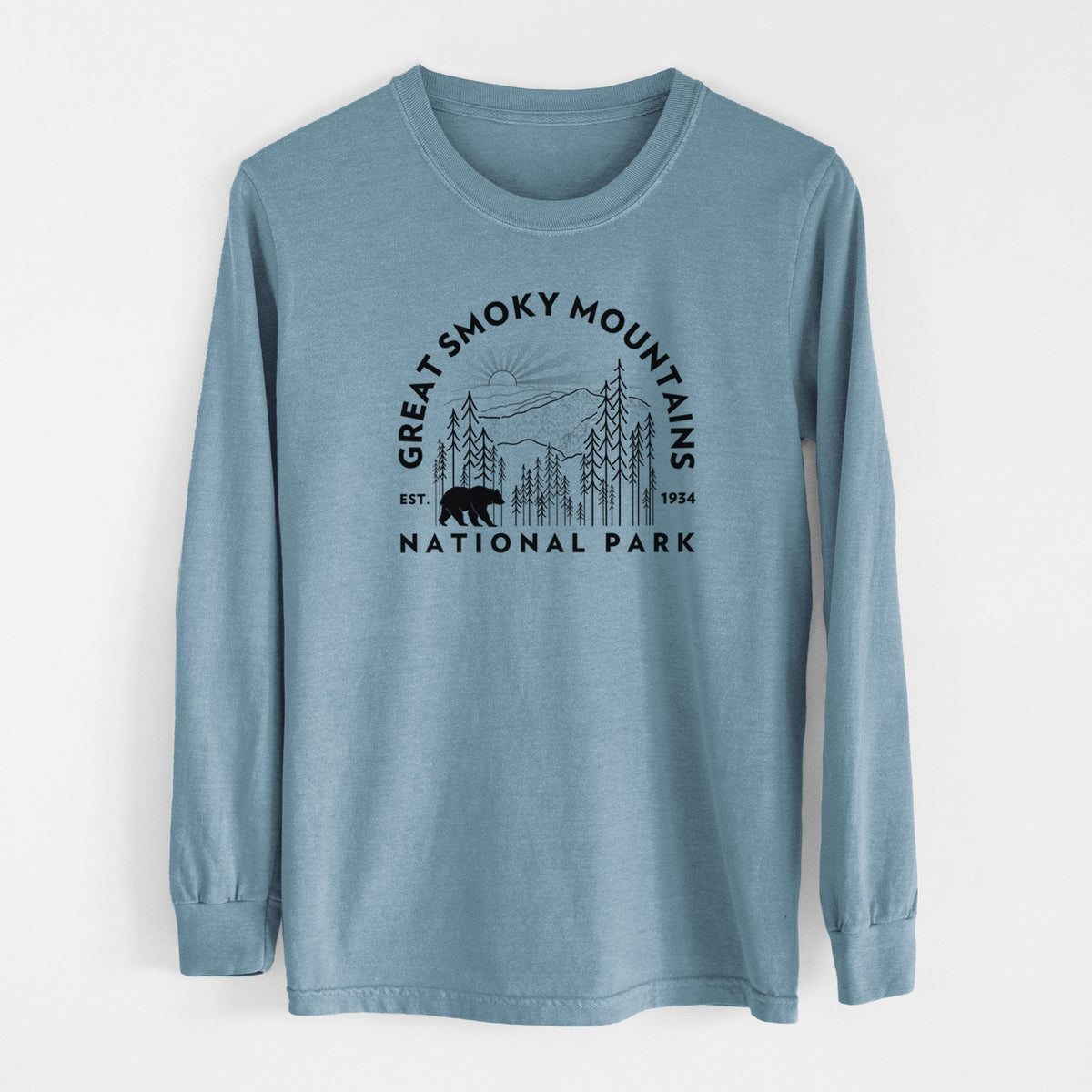 Steel blue Comfort Colors long sleeve shirt laid flat, printed with a round badge of mountains, pine trees and a black bear, with the words Great Smoky Mountains National Park, Est. 1934.