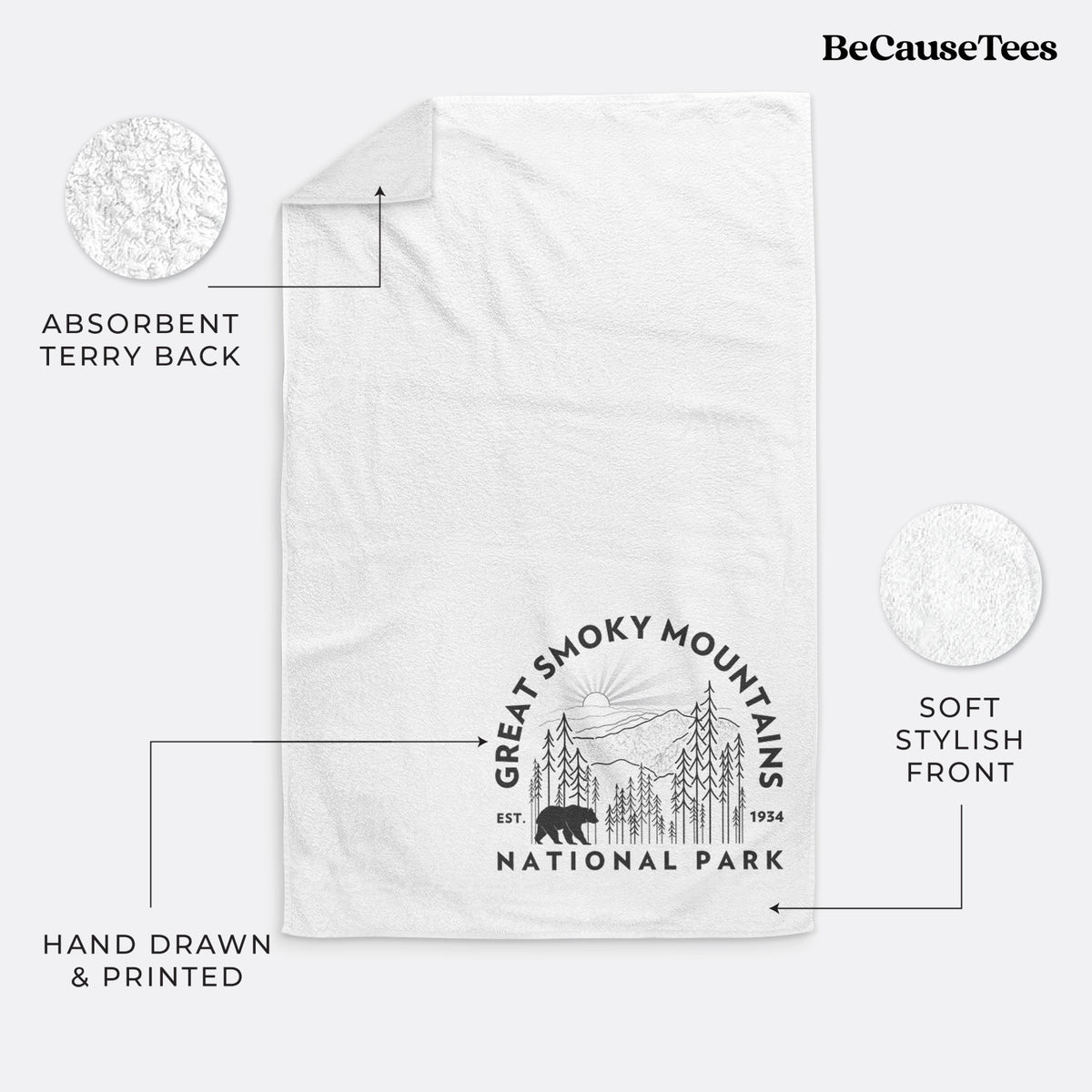 White hand towel printed with a round badge of mountains, pine trees and a black bear, with the words Great Smoky Mountains National Park, Est. 1934.