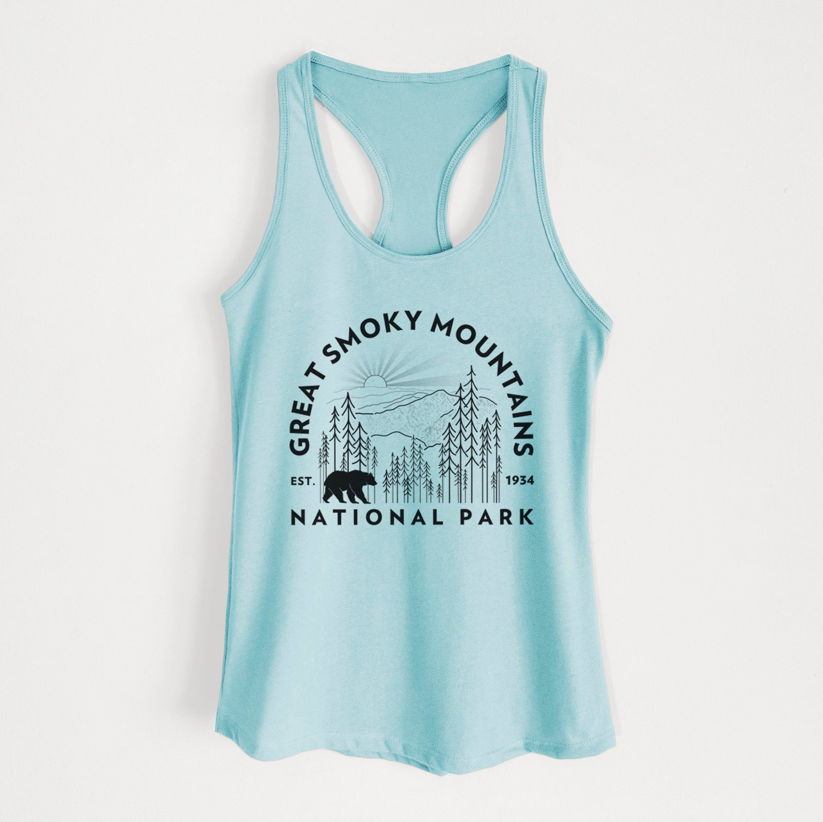 Banana cream women's racerback tank top laid flat, printed with a round badge of mountains, pine trees and a black bear, with the words Great Smoky Mountains National Park, Est. 1934.