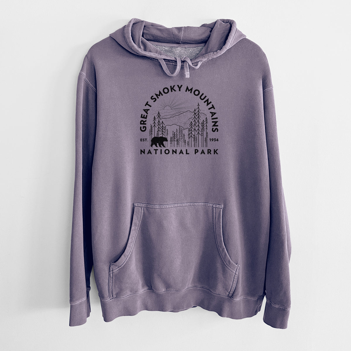 Plum purple pigment dyed hoodie laid flat, printed with a round badge of mountains, pine trees and a black bear, with the words Great Smoky Mountains National Park, Est. 1934.