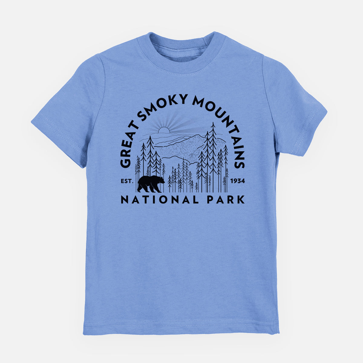 Carolina blue youth t-shirt laid flat, printed with a round badge of mountains, pine trees and a black bear, with the words Great Smoky Mountains National Park, Est. 1934.