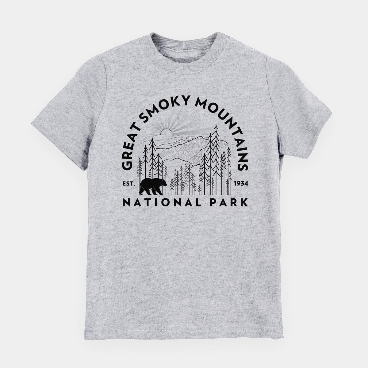 Heather grey youth t-shirt laid flat, printed with a round badge of mountains, pine trees and a black bear, with the words Great Smoky Mountains National Park, Est. 1934.