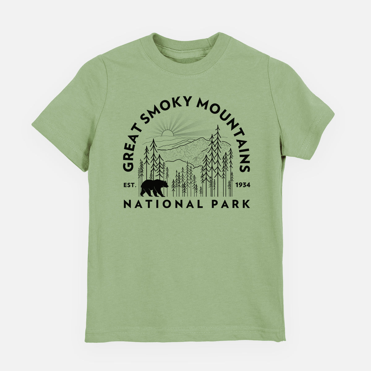 Sage green youth t-shirt laid flat, printed with a round badge of mountains, pine trees and a black bear, with the words Great Smoky Mountains National Park, Est. 1934.