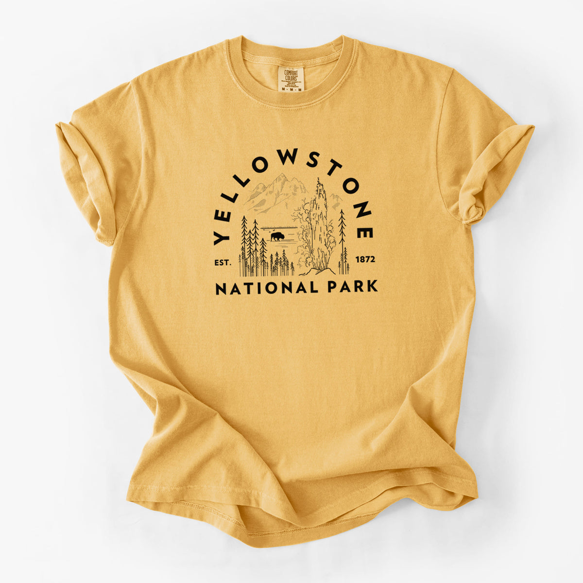 Golden wheat yellow Comfort Colors t-shirt laid flat, printed with a round badge of a waterfall, pine trees and a bison, with the words Yellowstone National Park, Est. 1872.