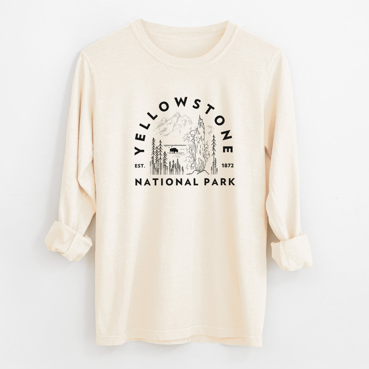 Ivory Comfort Colors long sleeve shirt laid flat with the cuffs rolled, printed with a round badge of a waterfall, pine trees and a bison, with the words Yellowstone National Park, Est. 1872.