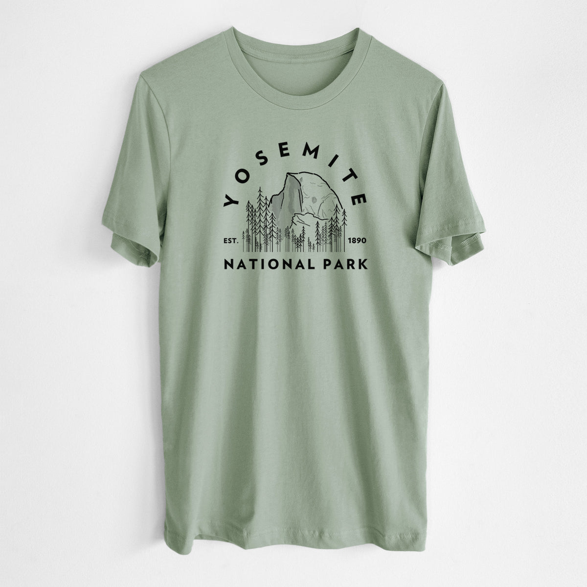 Sage green lightweight cotton t-shirt laid flat, printed with a round badge of Half Dome and pine trees, with the words Yosemite National Park, Est. 1890.