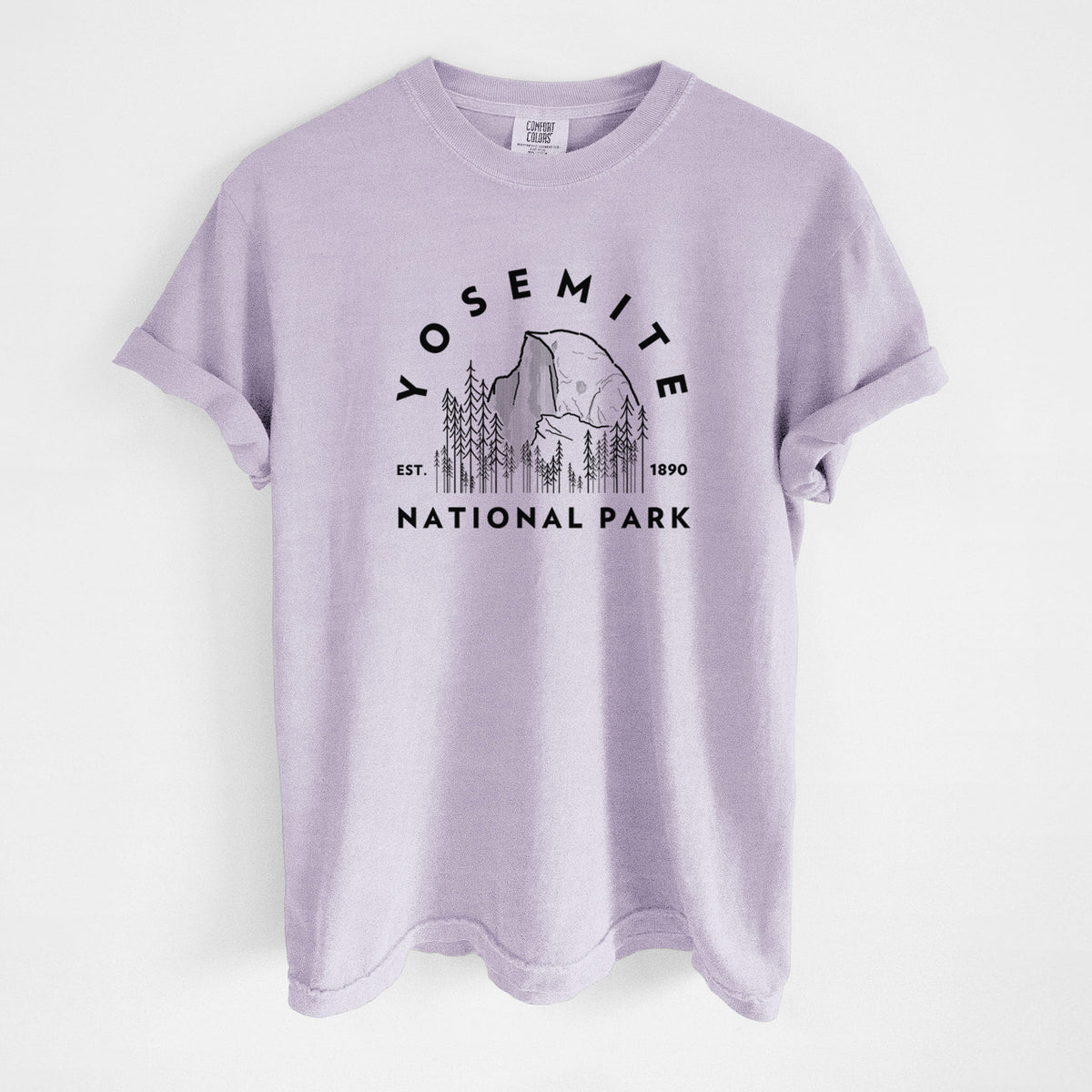 Orchid purple Comfort Colors t-shirt laid flat, printed with a round badge of Half Dome and pine trees, with the words Yosemite National Park, Est. 1890.